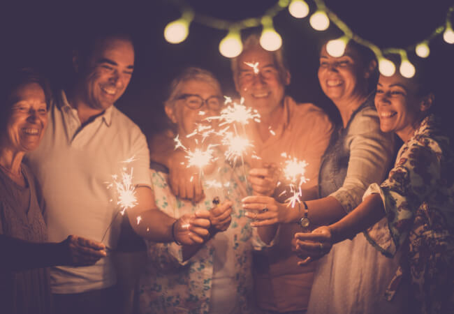 group of friends with sparklers celebrating
